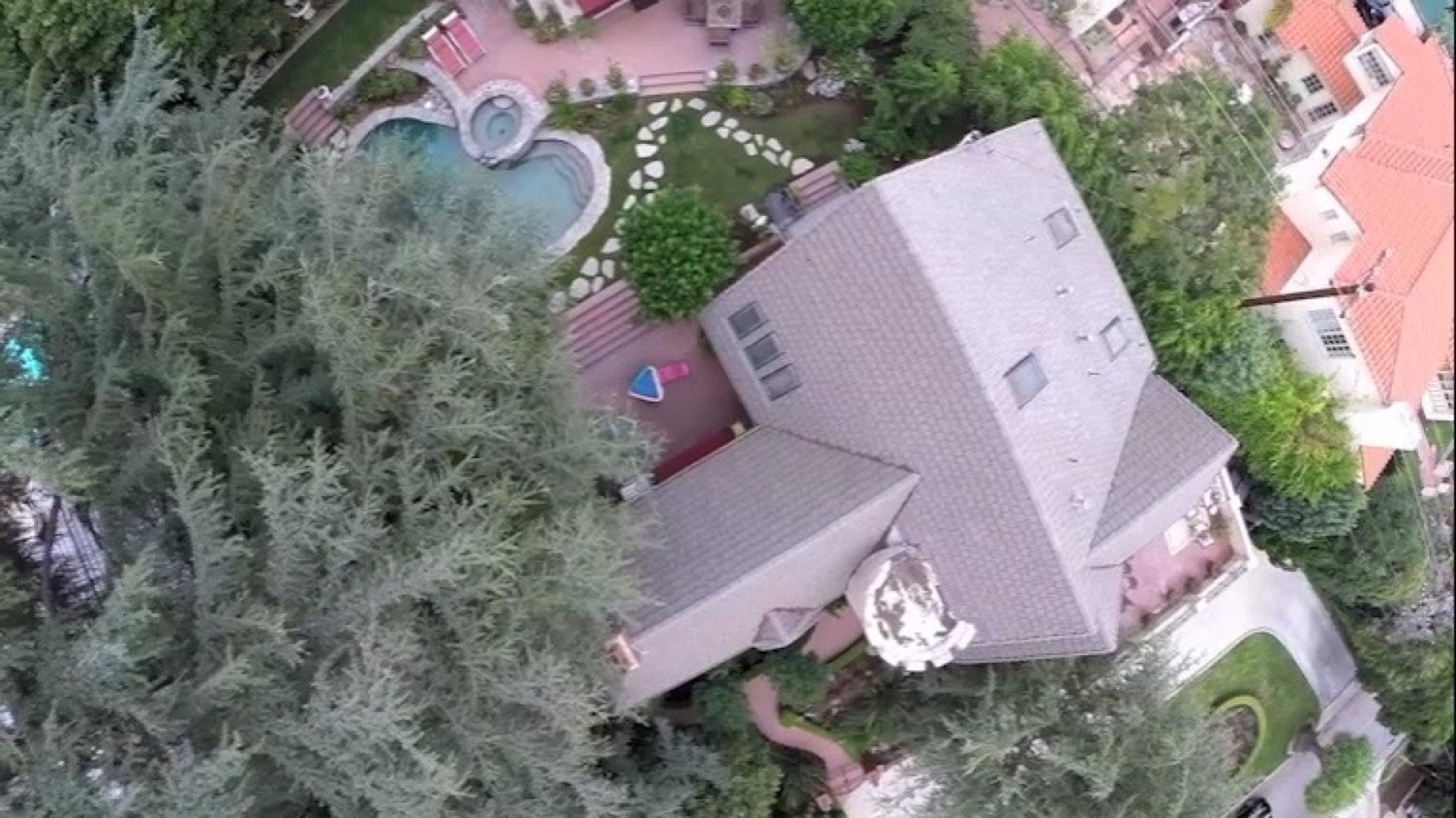 Aerial overview of the residence, pool, spa and landscaped grounds